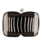 The Peek wallet by Bed|Stü is a small brown zippered accessory made from premium leather, shown open to reveal multiple empty accordion-style card slots, and photographed against a white background.