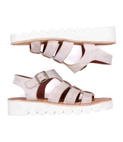Two Bed|Stü Perfect sandals featuring beige leather straps, gold buckles, and thick white scalloped platform soles are positioned parallel to one another on a white background.