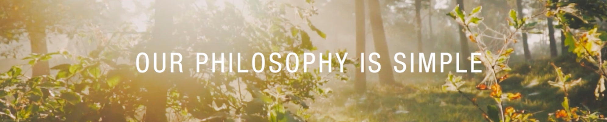Sunlit forest banner with the text “Our Philosophy Is Simple.”
