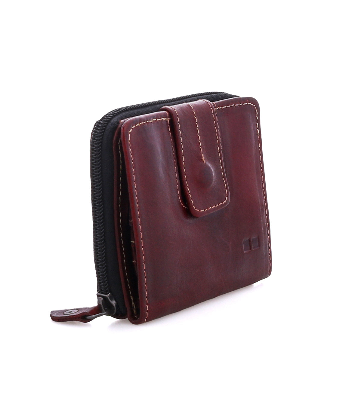 The Bed|Stü Plus is a dark brown bifold wallet with white stitching, featuring a zipper closure along the side and a snap button flap on the front. It includes a convenient zippered coin pocket and is photographed on a white background.