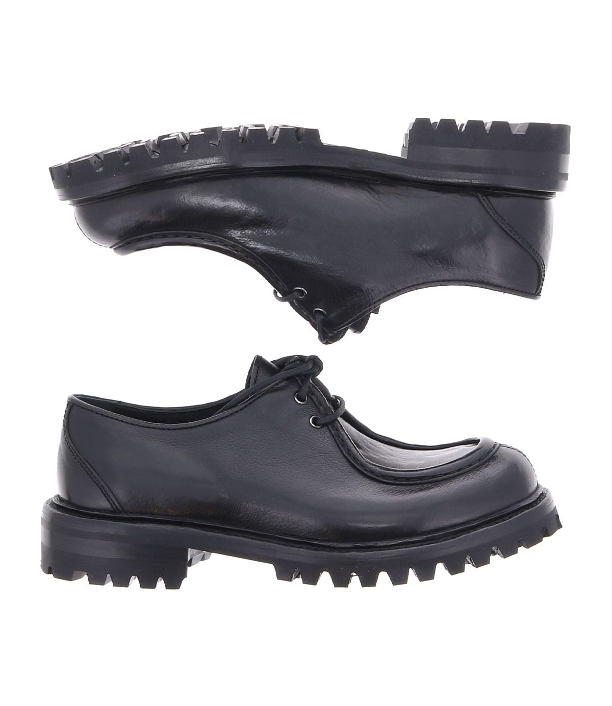 A pair of black leather Portare lace-up shoes by Bed|Stü, featuring thick, rugged soles and shown from the side and bottom angles on a white background, evoke the classic appeal of vintage-inspired boots.
