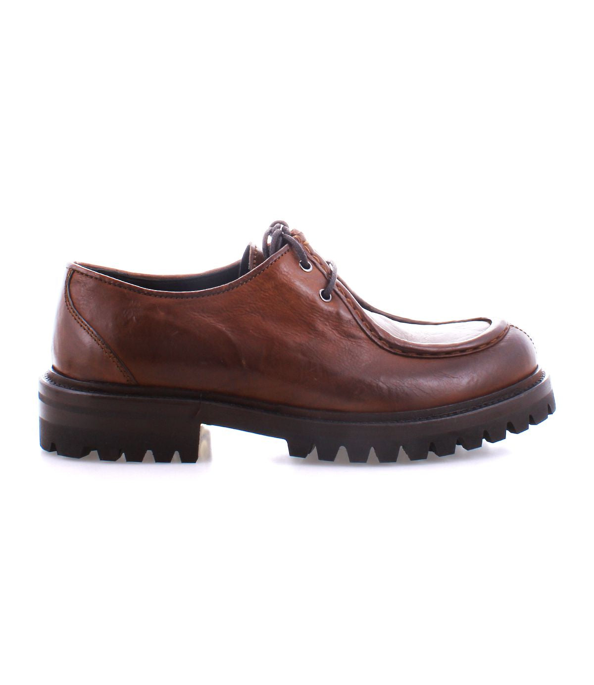 The Bed|Stü Portare is a brown leather moc-toe lace-up boot featuring a rugged black rubber sole, shown in profile against a white background.