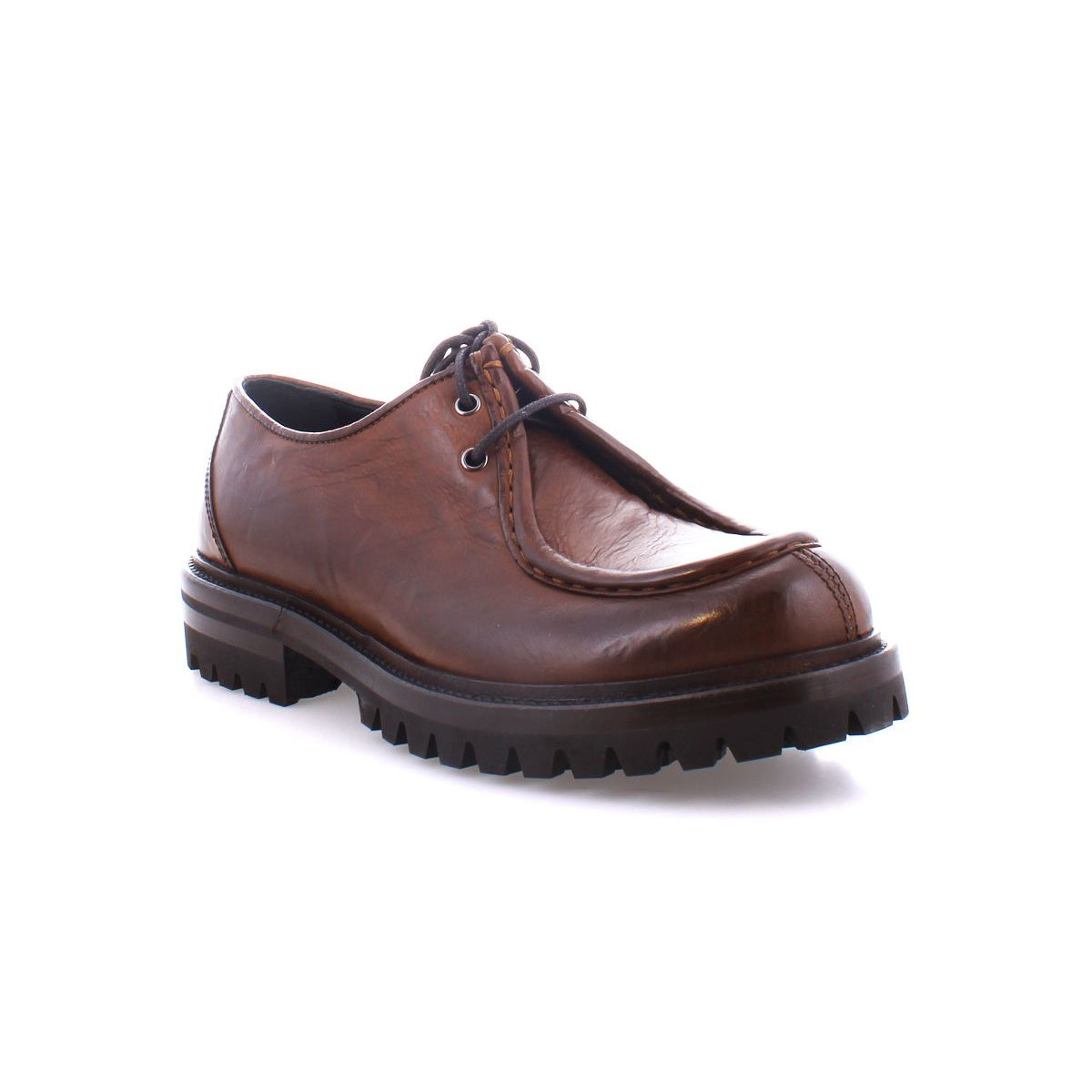 The Bed|Stü Portare is a brown leather moc-toe lace-up boot featuring a thick, rugged black sole, shown here against a white background.