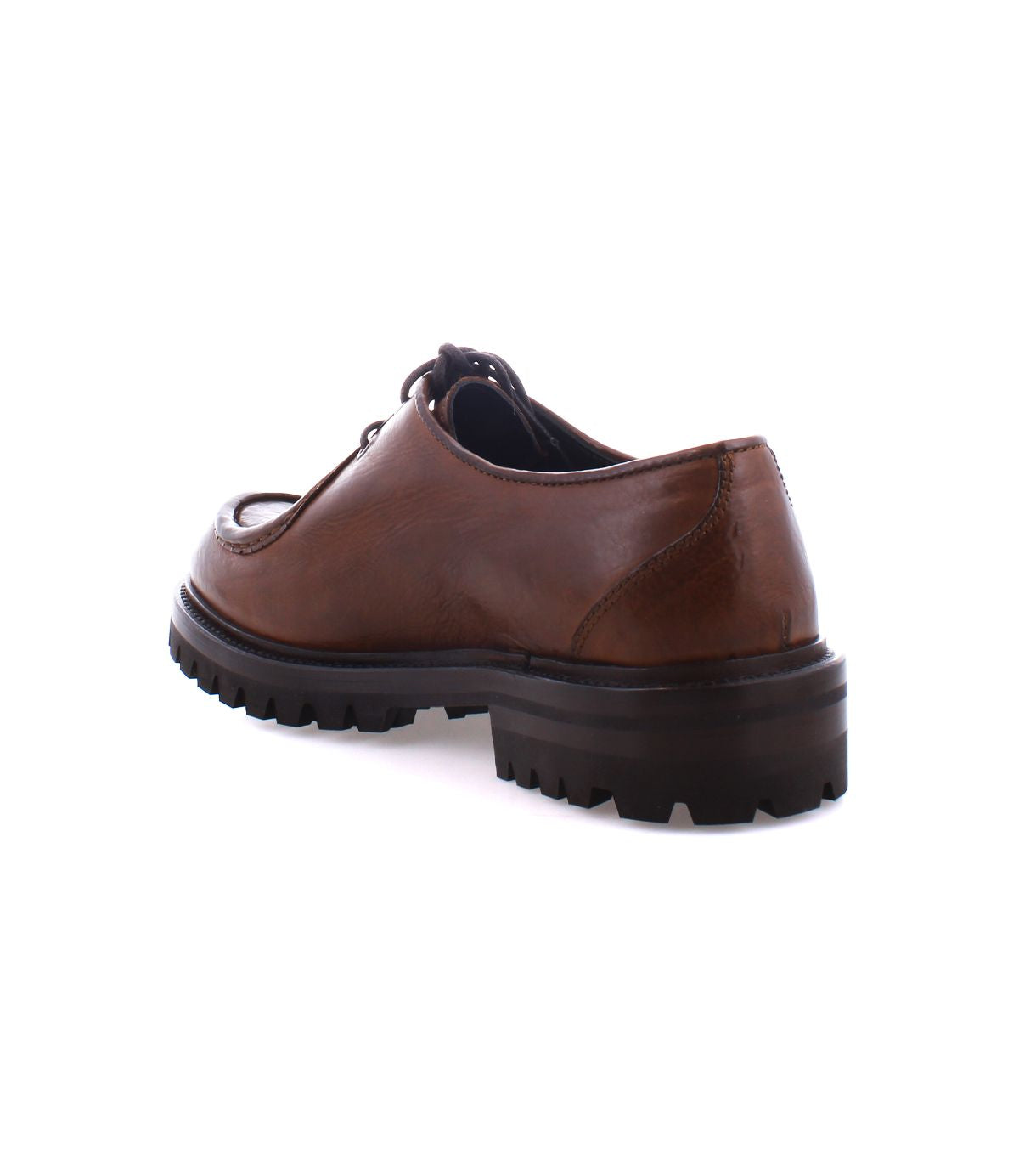 The Bed|Stü Portare brown leather dress shoe, featuring a thick black treaded sole and vintage-inspired boot details, is displayed from a rear diagonal angle against a white background.