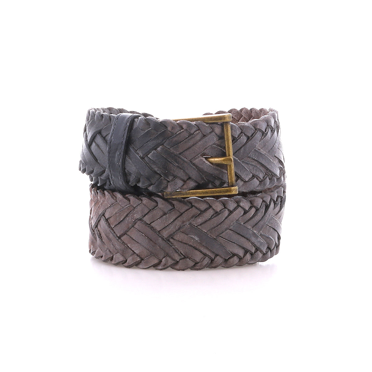 A handwoven leather belt by Bed|Stü, the Proem, showcases artisan detailing and a vintage metal buckle, rolled up and displayed against a white background.