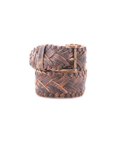 The Bed|Stü Proem is a rolled brown handwoven leather belt featuring artisan detail and a vintage metal buckle, displayed on a white background.