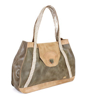 Introducing the Proper everyday tote by Bed|Stü, crafted from premium vegetable-tanned olive and tan leather for enduring durability and timeless style. This spacious bag features handwoven, light-hued straps, a secure flap closure, and is finished with a small metal clasp on the front.