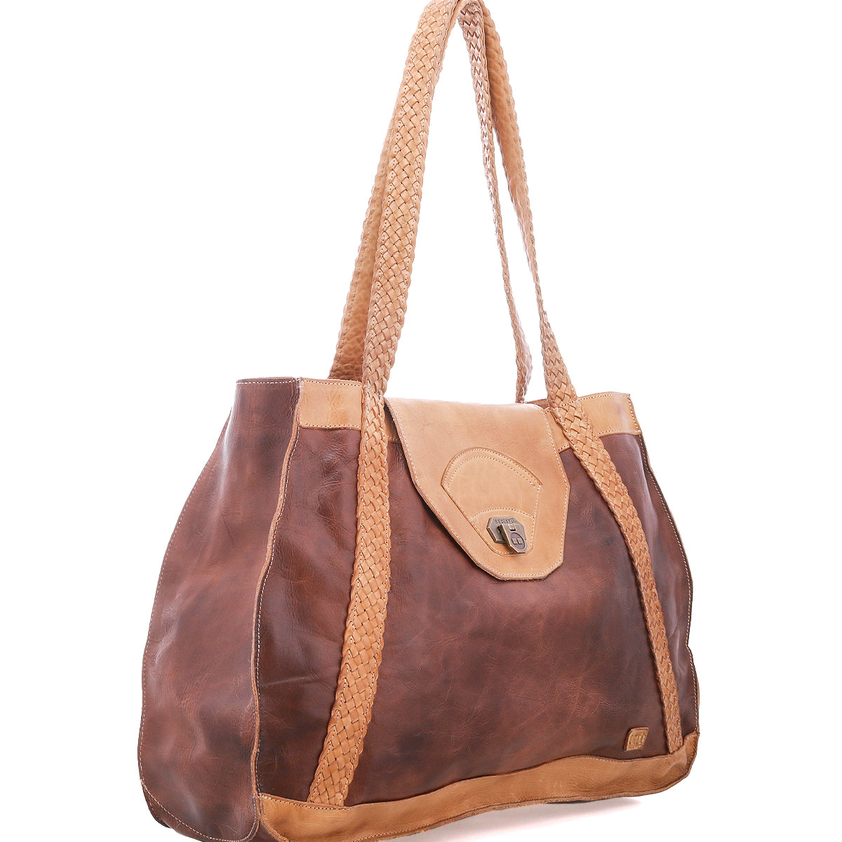 The Proper by Bed|Stü is a brown, vegetable-tanned leather everyday tote with handwoven straps and a flap closure, shown on a white background.