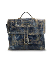 Bed|Stü's Pub satchel features distressed leather, silver stud accents, a top handle, front flap, and an oversized buckle closure—making it a stylish travel companion or an eye-catching alternative to the classic leather briefcase.