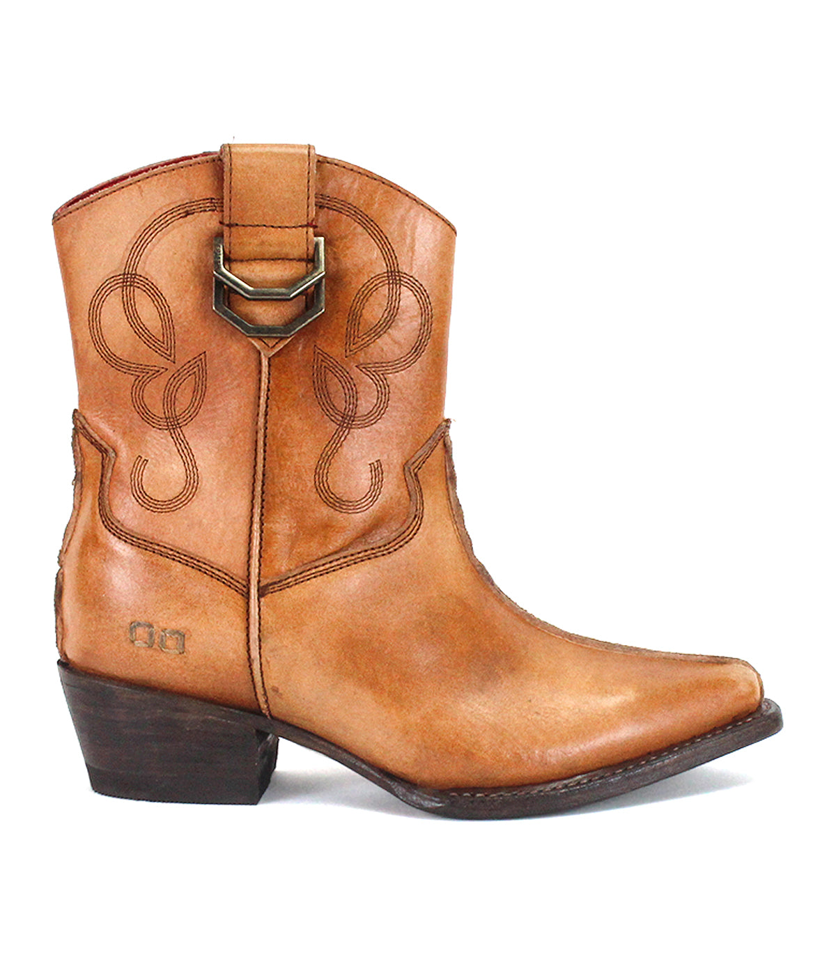 The Bed|Stü Rangeley is a tan leather cowboy boot with decorative stitching and distinctive design elements, featuring a side pull strap, pointed toe, and a short stacked heel. Displayed in side profile against a white background.