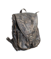 The Bed|Stü Ranger is a distressed brown leather backpack featuring a front pocket, top handle, and a flap closure with metal buckle—this sturdy backpack is ideal for everyday wear and is showcased against a white background.