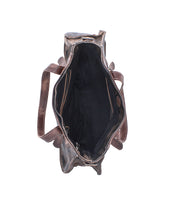 Top view of the Bed|Stü Redrock handbag, revealing its heritage-inspired brown leather design with a spacious black interior, a zippered pocket, and two smaller side pockets, along with buckled handles visible on each side.
