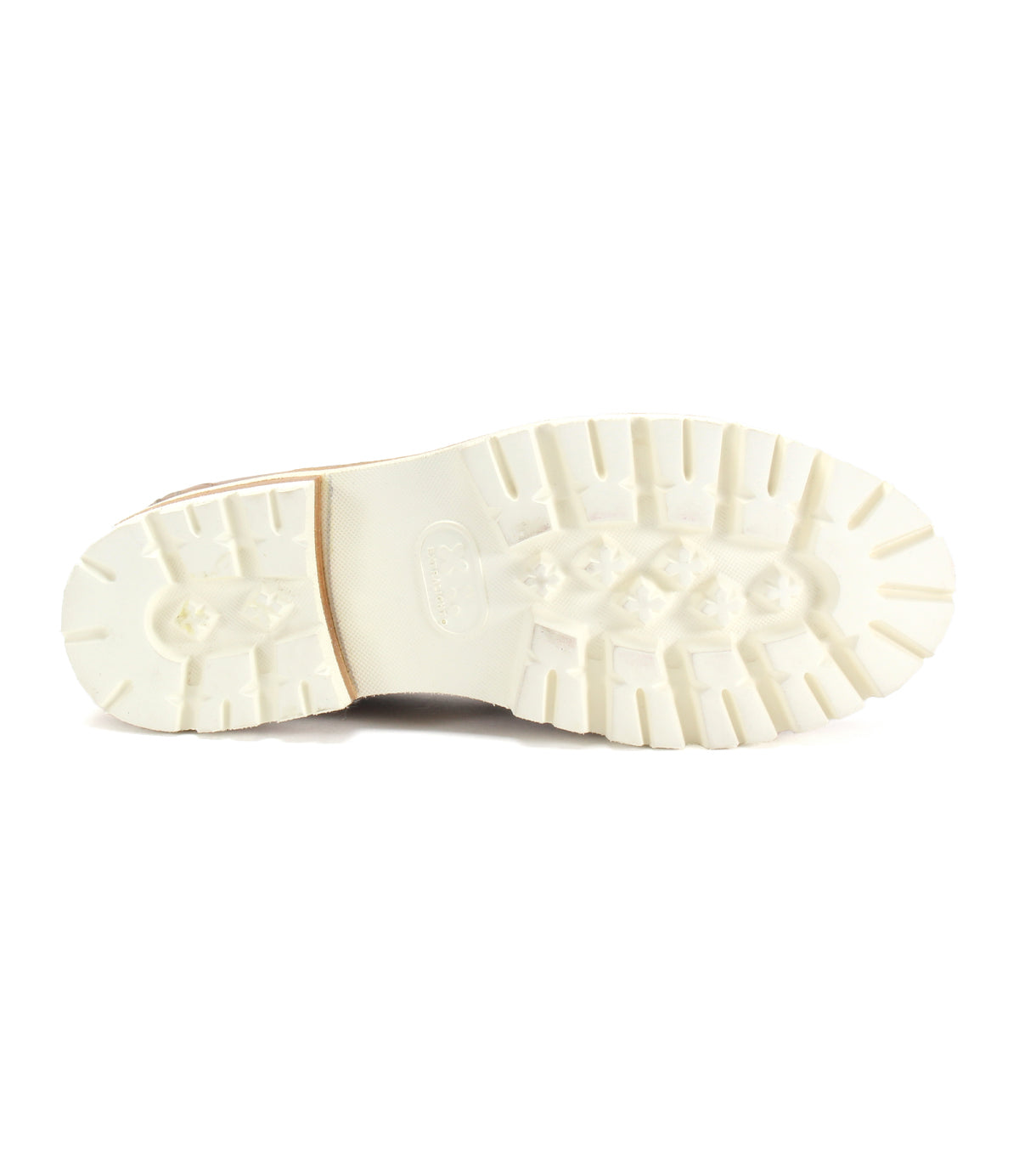 The image features the bottom view of a white rubber sole with a rugged, textured tread pattern, perfectly complementing the modern essential style of the Reina III penny loafer from Bed|Stü, which is crafted from hand-finished leather.