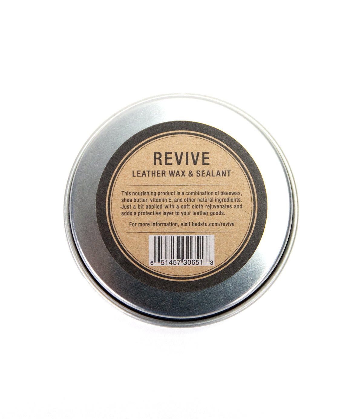 A round metal tin labeled "Revive Leather Wax/Sealant" by Bed|Stü, with product details and a barcode displayed on the lid, is shown from above against a white background. This premium leather care essential features a natural wax-based formula designed to restore and protect your favorite items.