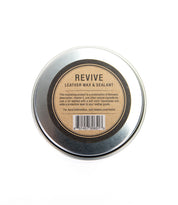 A round metal tin labeled "Revive Leather Wax/Sealant" by Bed|Stü, with product details and a barcode displayed on the lid, is shown from above against a white background. This premium leather care essential features a natural wax-based formula designed to restore and protect your favorite items.