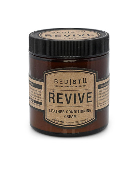 Amber jar of BED|STU Revive leather conditioning cream with a black screw-top lid.