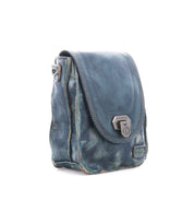 The Rhyme shoulder bag by Bed|Stü, crafted from distressed blue leather with a flap closure and metallic clasp, is displayed on a white background; this versatile crossbody offers a hands-free way to carry your essentials in style.
