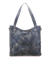 Introducing the Ridgefield by Bed|Stü—a blue distressed full-grain leather tote bag featuring dual straps and a signature metal brand plate at the lower front center. Designed for everyday use, this tote offers an organized interior to keep your essentials neat and easily accessible.