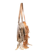 Two Rimes tote shoulder bags by Bed|Stü, one in light gray and one in tan, hang side by side against a white background. Each handcrafted leather bag features fringe detailing and a spacious interior, combining style with practical functionality.