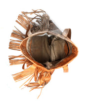 The Bed|Stü Rimes is a handcrafted brown leather tote featuring eye-catching fringe detail, shown with two handles and an open top view that reveals a spacious interior—all set against a white background.