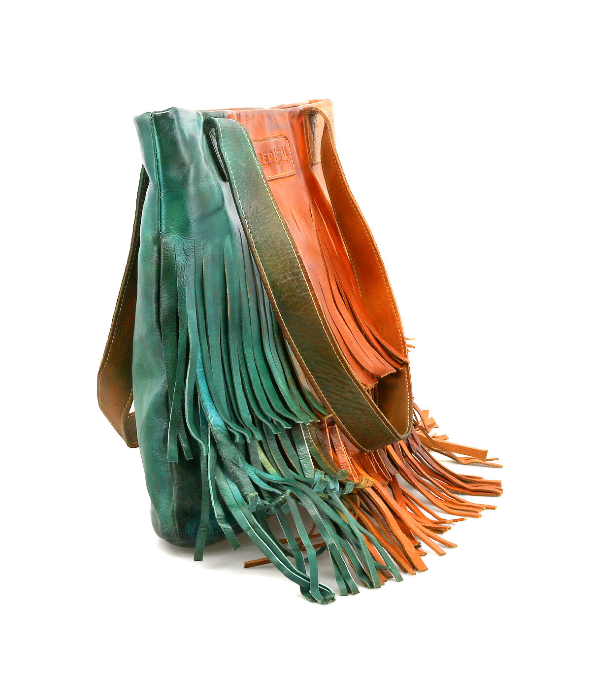Introducing the Rimes by Bed|Stü—a handcrafted leather tote with long fringe detailing, showcased in bold green and brown hues. This stylish bag features a spacious interior, two sturdy shoulder straps, and a sleek rectangular silhouette.