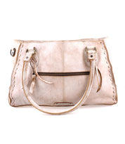 The Rockababy SL by Bed|Stü is a beige upcycled leather handbag featuring double handles, a front zipper pocket, and decorative stitching along the edges, displayed against a white background.
