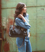 A stylish woman carrying a Bed Stu Rockababy handbag.