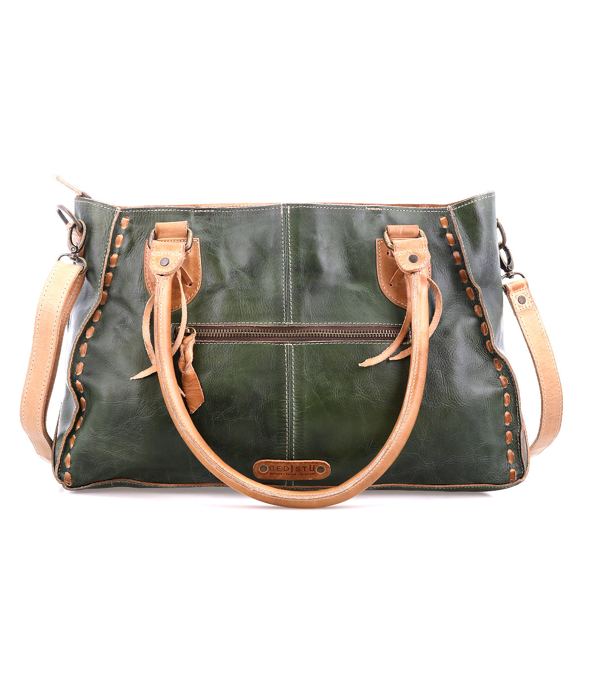 The Bed|Stü Rockababy handbag, crafted from green vegetable-tanned leather with tan handles and trim, features decorative stitching, a front zipper pocket, and a compact design. Shown against a white background.