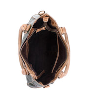 Top view of the Rockababy by Bed|Stü, an open compact leather bag with tan handles, tan edges, and a dark interior featuring pockets and a zippered compartment. This stylish handbag is crafted from vegetable-tanned leather for enhanced durability and timeless appeal.