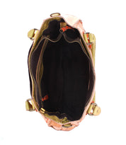 Top view of the Bed|Stü Rockababy, an open compact bag crafted from vegetable-tanned leather, revealing a black fabric-lined interior with a zipper pocket and open compartments, set against a white background.