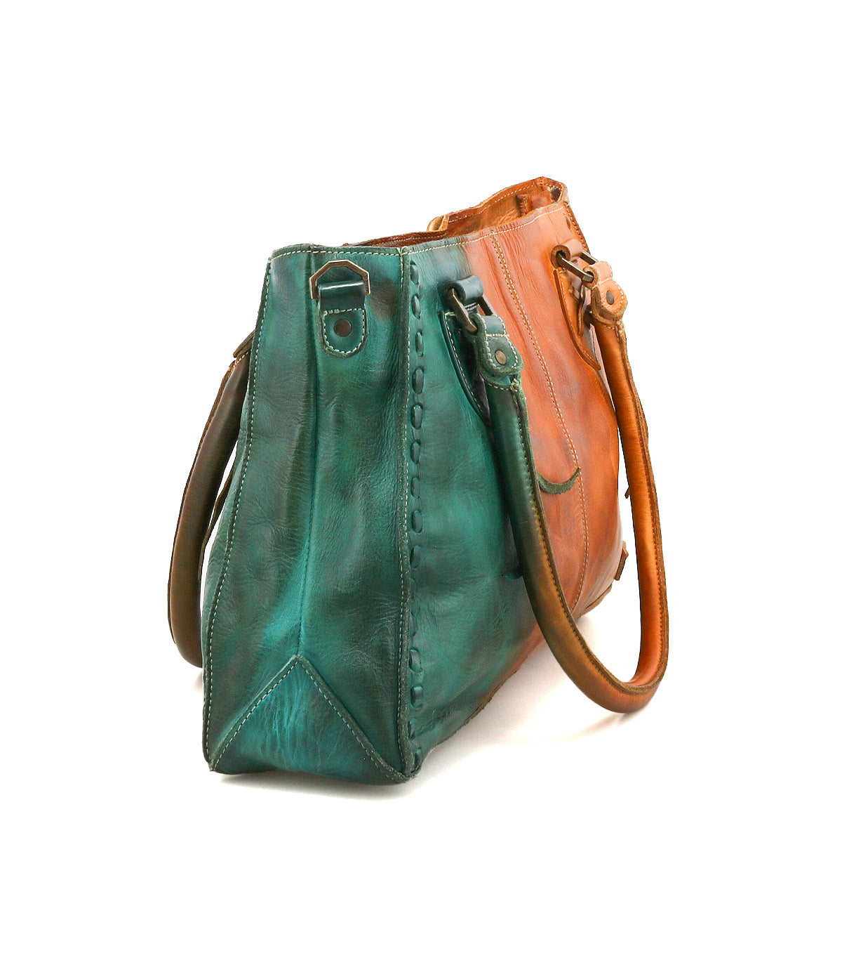The Bed|Stü Rockababy is a compact handbag crafted from vegetable-tanned leather, showcasing one side in teal and the other in brown. Designed with two handles and visible stitching for a distinctive look, it is displayed here against a white background.