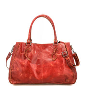 The Rockaway by Bed|Stü is a large red full-grain leather handbag featuring two handles, an adjustable shoulder strap, and decorative side stitching, designed for everyday use and showcased against a plain white background.