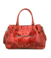 The Bed|Stü Rockaway is a spacious red handbag, expertly crafted from full-grain leather with dual handles, a front zipper pocket, and a detachable shoulder strap—displayed on a white background and designed for everyday functionality.