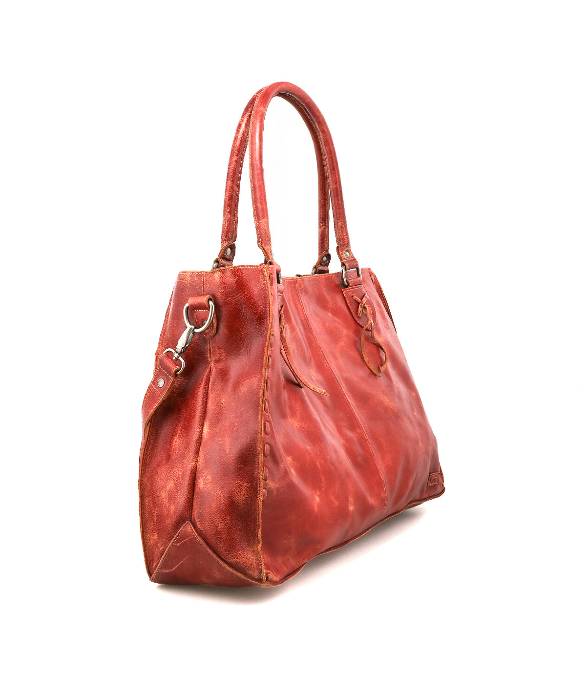 The Bed|Stü Rockaway is a large, red full-grain leather handbag featuring double handles, metal hardware, and decorative stitching, displayed at an angle against a white background.