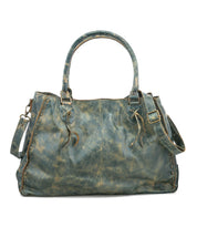 The Rockaway handbag by Bed|Stü is crafted from distressed blue full-grain leather and features dual handles, a detachable shoulder strap, and decorative stitching along the sides—making it a stylish accessory designed for everyday use.