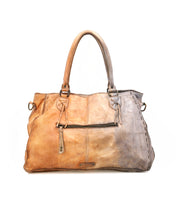Bed|Stü’s Rockaway handbag features dual handles, a front zipper pocket, decorative stitching, and a tag. Crafted from full-grain leather with a slightly distressed, two-tone finish, the Rockaway combines everyday practicality with visible texture and seams for a stylish accessory.