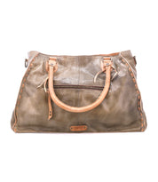 Presenting the Rockaway handbag by Bed|Stü: a spacious brown full-grain leather bag featuring tan handles, visible stitching, and a convenient front zippered pocket. Shown against a white background, this accessory blends timeless style with durable craftsmanship—perfect for everyday use.