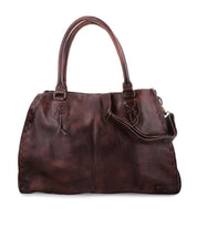 The Bed|Stü Rockaway is a large, dark brown full-grain leather handbag featuring double handles and an adjustable shoulder strap, designed for everyday use and showcased against a white background.
