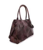 The Rockaway by Bed|Stü is a dark brown full-grain leather handbag featuring double handles, a side strap, and visible stitching, designed for everyday function and displayed against a white background.