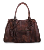 The Bed|Stü Rockaway is a dark brown full-grain leather handbag featuring double handles, a front zipper pocket, and stitched detailing along the sides. Designed for everyday function, it is displayed against a white background.