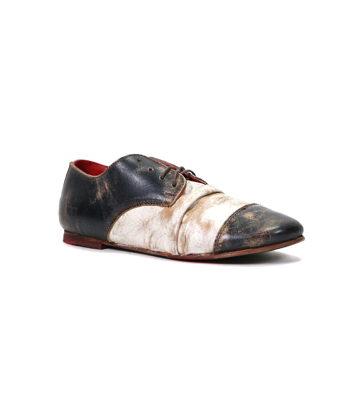 The Bed|Stü Rumba II is a single black and white lace-up leather oxford shoe with visible scuff marks and a worn appearance, photographed against a plain white background, effortlessly combining vintage charm with stylish comfort.