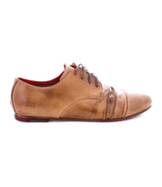 A single Rumba II lace-up dress shoe by Bed|Stü in tan leather, featuring dark laces, a low heel, visible creasing at the toe, and a slightly worn finish, is displayed on a white background. This classic design from Bed|Stü blends timeless appeal with stylish comfort.