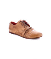 The Bed|Stü Rumba II is a tan lace-up leather shoe, highlighted by decorative stitching and pleated side detailing for stylish comfort, displayed against a white background.