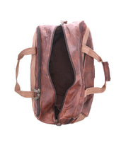 The Bed|Stü Ruslan brown leather duffel bag features durable canvas straps and is displayed from above with its main zipper open, revealing an empty interior against a white background.