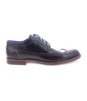 The Sandro II by Bed|Stü is displayed in a side profile view—a single handcrafted leather dress shoe in classic black with a brown sole, elegant wingtip broguing, and blue interior lining.