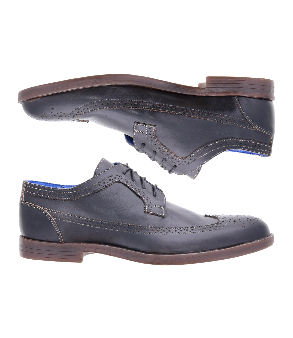 A pair of Sandro II by Bed|Stü, black handcrafted leather dress shoes featuring elegant wingtip broguing, brown soles, and a blue inner lining, are shown from the side on a white background.