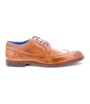 The Bed|Stü Sandro II is a handcrafted leather dress shoe in rich brown, showcasing classic wingtip broguing, laces, and a low heel, displayed in a left side profile on a white background.