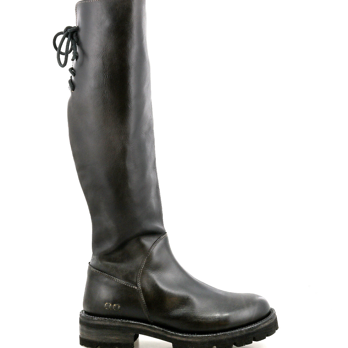 Introducing Scope by Bed|Stü: a tall boot made from sleek vegetable-tanned leather, designed with a side zipper, thick treaded sole, and distinctive lace-up detail along the back of the shaft—featured here in profile against a white background.