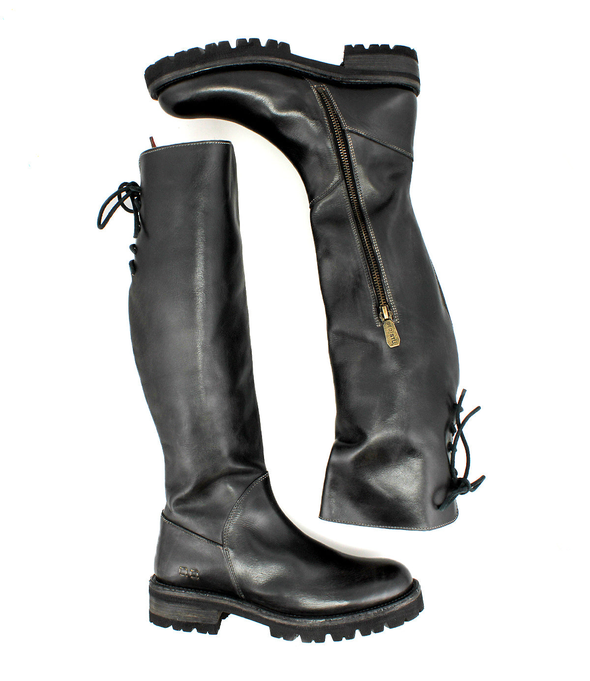 The Bed|Stü Scope boots are tall leather boots crafted from premium vegetable-tanned leather, featuring side zippers, rugged soles, and a distinctive lace-up back design, displayed on a white background.