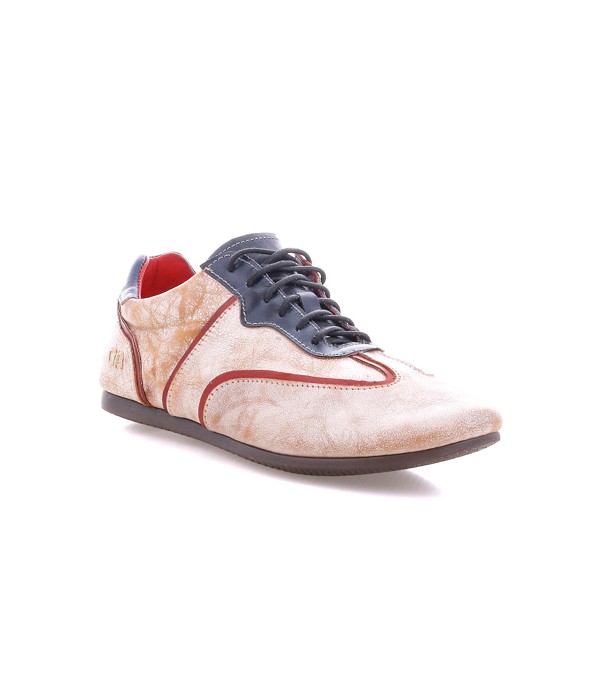 The Scurry II by Bed|Stü is a beige and brown casual sneaker with red accents, black laces, and a thin rubber sole. It features a classic lace-up design and a low-profile silhouette, shown against a white background.